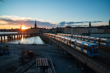 Sunset view of Gamla Stan and Stockholm metro train from Slussen