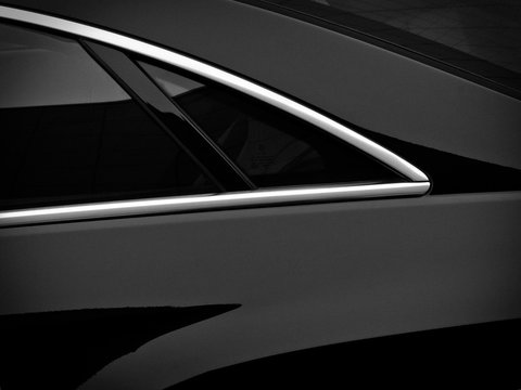 Rear side window on a black passenger car. Fragment