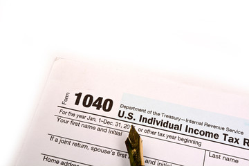 Completing US tax return form 1040 on white background
