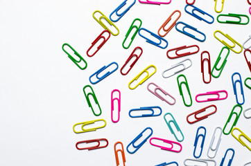 Colorful paper clips to documents lying on a white background