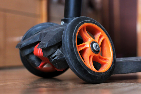 Orange scooter wheels, three-wheeled transport