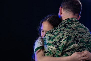 Soldier hugs daughter on departing or returning