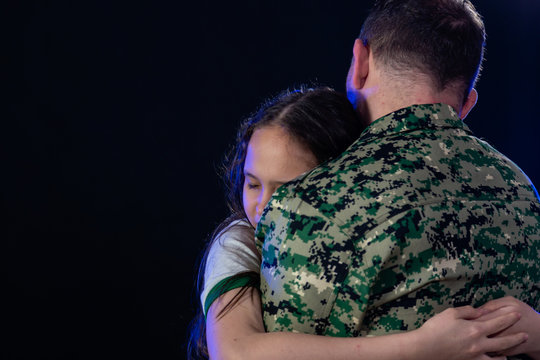 Soldier hugs daughter on departing or returning