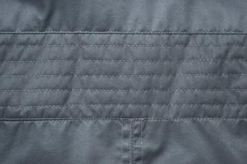 texture of black fabric stitched with threads. Jacket detail