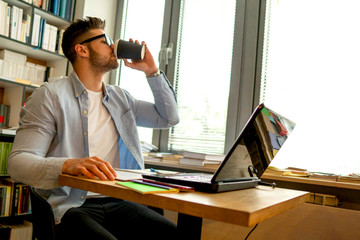 Male student in library, learning for exam