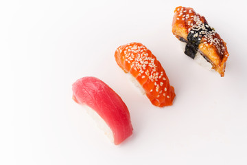 Creative layout with various sushi on white background. Shrimp, eel, tuna.