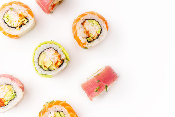 Flat lay with colorful sushi rolls with crab meat on white background