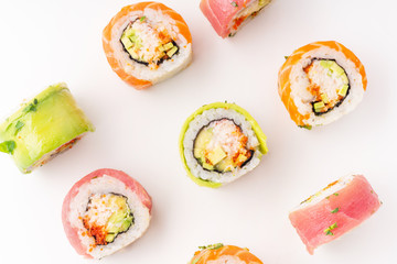 Flat lay with colorful sushi rolls with crab meat on white background