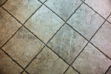 Old grey tiles on the floor. Texture background.