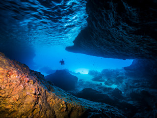 Seascape of coral reef in the Caribbean Sea around Curacao at dive site Blue Room, a special cave