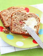 Two piecies Banana bread healthy tasty breakfast Loaf walnuts icing cream cheese Green light plate background Selective focus