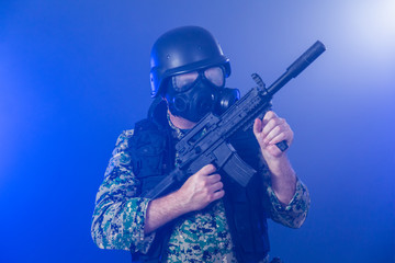 Soldier holding assault rifle in smoky haze
