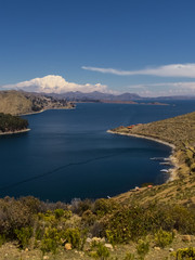 Fototapeta na wymiar Terraced landscape of Isla del Sol with Andes mountains in the background on the Bolivian side of Lake Titicaca