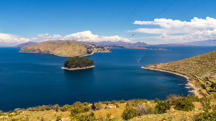 Fototapeta premium Terraced landscape of Isla del Sol with Andes mountains in the background on the Bolivian side of Lake Titicaca
