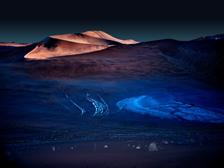 desert of namib at night with orange sand dunes and starry sky