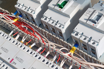 Electrical wires or cables are laid in a cable channel and connected to circuit breakers and modular magnetic contactors. Circuit breakers, contactors are fixed to the panel in the electrical Cabinet.
