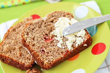 Two piecies Banana bread healthy tasty breakfast Loaf walnuts icing cream cheese Green light plate background Selective focus
