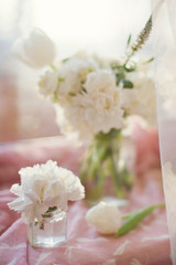 white carnations in glass jar