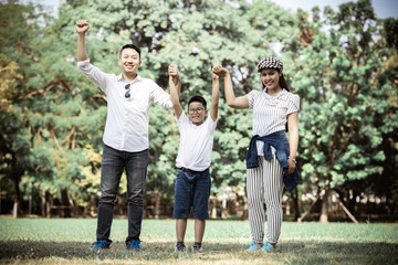 Happy children and parents playing in the park. Concept family relaxation.