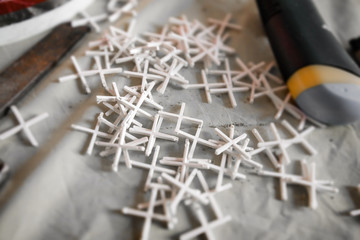 Plastic tile spacers on floor. Installing new tiles in bathroom, shower or kitchen back splash...