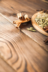 Seasoning on a textured wooden background close-up and copy space. Cinnamon, star anise, fennel, cloves, seasoning tea masala as a texture