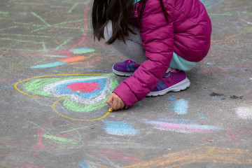 Outdoor kids graffiti on the floor with chalk