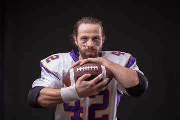 Close up portrait of American Football Player with ball
