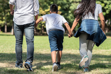 Fototapeta premium Happy children and parents playing in the park. Concept family relaxation.