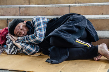 Homeless man sleep on street.