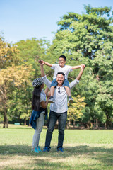 Happy children and parents playing in the park. Concept family relaxation.