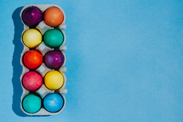 Easter background with Easter eggs. Top view with copy space. multicolored Easter eggs on a blue background