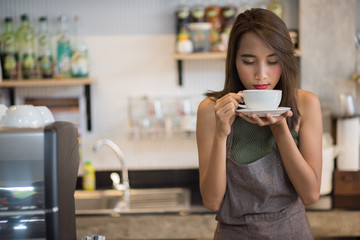 Young beautiful asian woman drinking coffee in cafe.