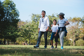 Happy children and parents playing in the park. Concept family relaxation.