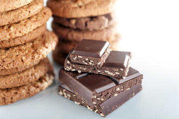 Various shortbread, oat cookies, chocolate chip biscuit and pieces of chocolate with seeds and nuts.