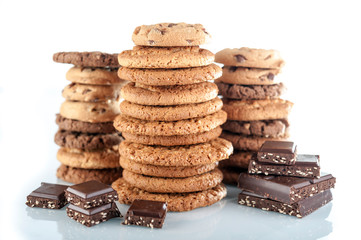 Various shortbread, oat cookies, chocolate chip biscuit and pieces of chocolate with seeds and nuts.