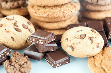 Various shortbread, oat cookies, chocolate chip biscuit and pieces of chocolate with seeds and nuts.