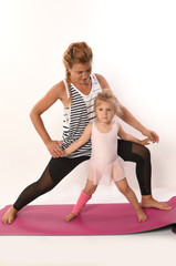 young woman and child practicing yoga on a white background