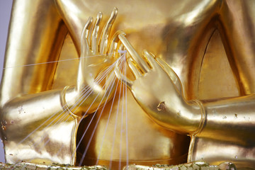 close up hand of golden buddha statue