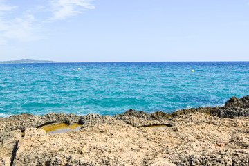 Fototapeta na wymiar stone rocky coast view of the blue sea wave landscape weather
