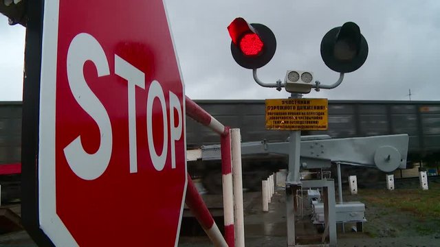 STOP sign red traffic light at a railway crossing