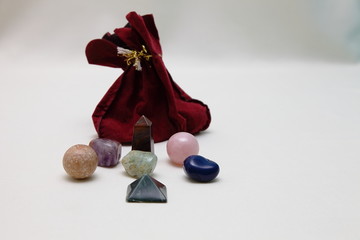 Magic Stones and crystals of various shapes and colors lying in bulk.
