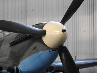 Close - up of old engine and propeller plane.