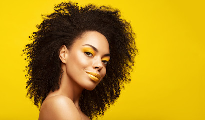 Summer portrait of African American Fashion Model  . Brunette young woman with afro hair style,creative yellow make up, lips and eyeshadows on colorful background. Summer beauty concept - obrazy, fototapety, plakaty