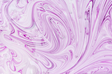 Empty abstract background for layouts. The process of mixing purple and white paint close-up. Light photo.