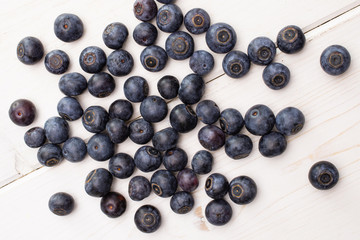 Lot of whole fresh sweet purple blueberry american flatlay on white wood