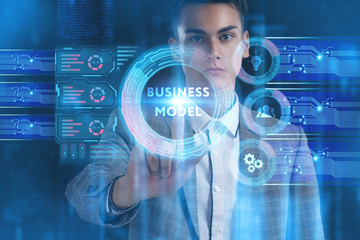 The concept of business, technology, the Internet and the network. A young entrepreneur working on a virtual screen of the future and sees the inscription: Business model