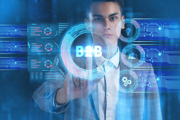 The concept of business, technology, the Internet and the network. A young entrepreneur working on a virtual screen of the future and sees the inscription: B2B