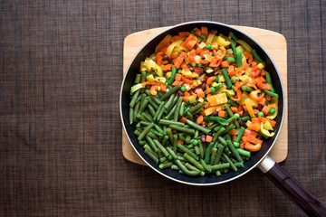 mix Fresh vegetables in a frying pan . fresh egg. celery stew, carrots, peas, bell peppers and tomatoes