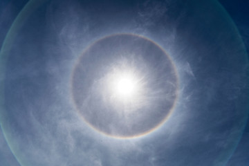 Astrophotography. Wonderful Sun halo with cloud in the sky in atmosphere, sun with circular rainbow, Corona ring of sun