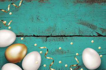 Close up of gold and white easter eggs on painted wooden blue background. Rustic grunge background. Easter eggs with golden serpentine and confetti. Invitation template design, greeting card